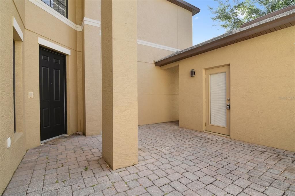 A private paver courtyard patio offers additional flexible outdoor space and then step through the front door and into your new home sweet home.