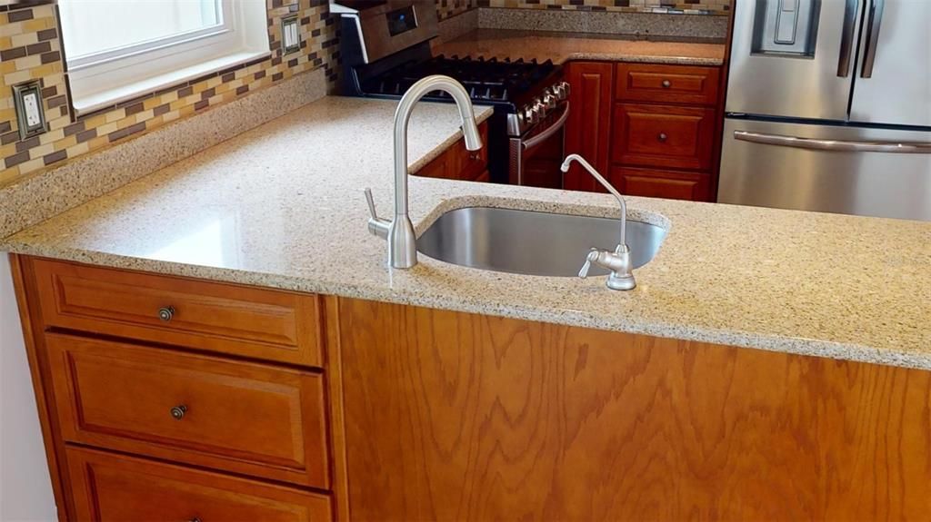 The breakfast bar not only provides additional seating and dining space but also includes extra storage and houses a reverse osmosis water filter, ensuring clean and purified drinking water.
