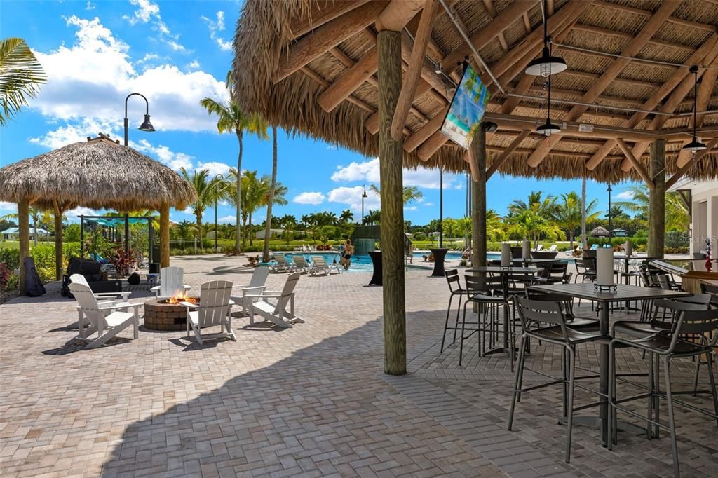 Coral Club tiki bar, pool, and fire pit with a pool view