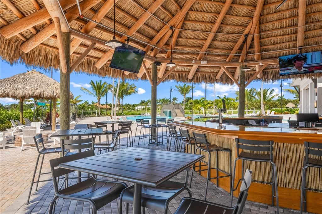 Coral Club tiki bar, pool, and fire pit with a pool view