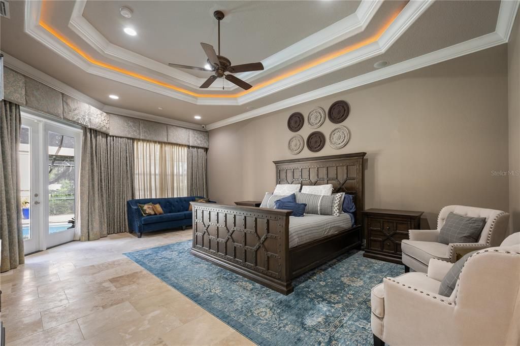 Primary Suite is made  cozy with mood lighting in coffered ceiling