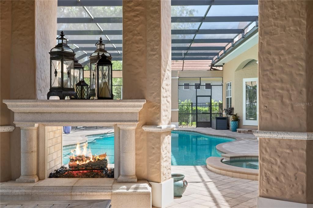 Fireplace is a focal point and separates the dining area from pool
