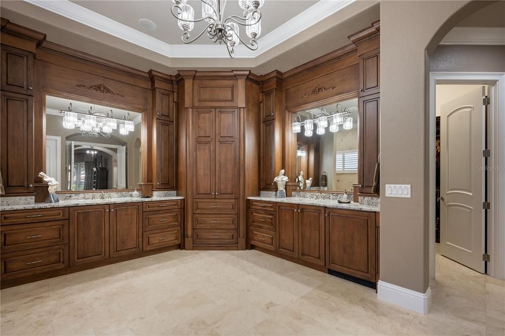 Dual vanities are separted by the private  entrance to the golfer's garage