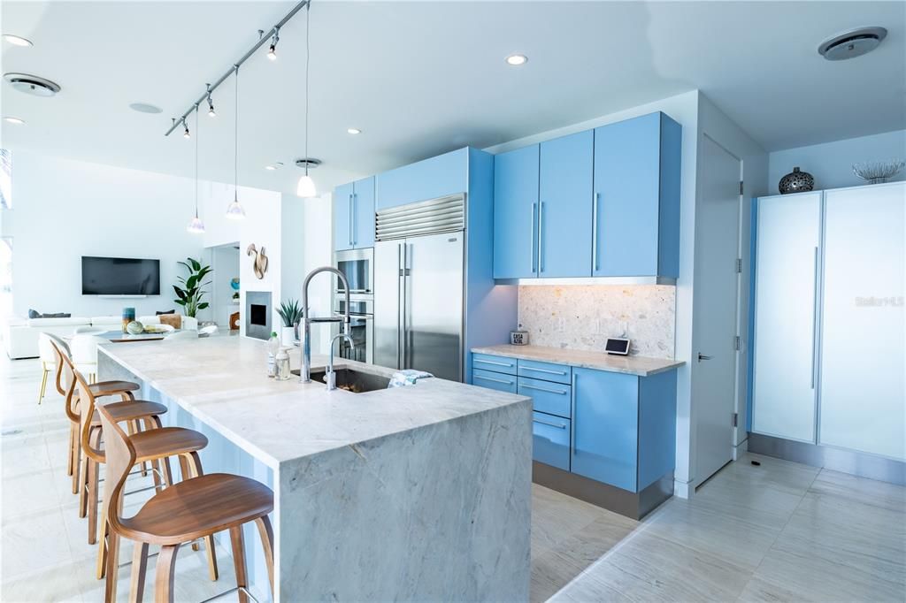 Kitchen with large island and oversized refrigerator