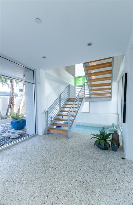 Dramatic Foyer with glass balls floating in circulating pool