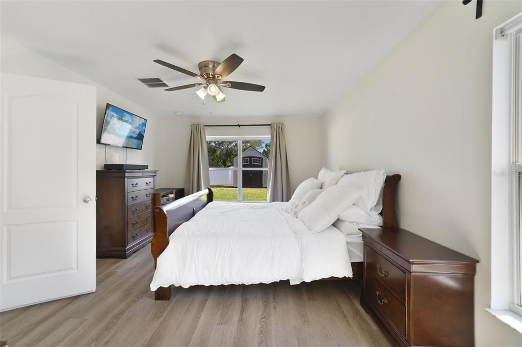 The ideal SPLIT BEDROOM layout delivers a generous PRIMARY SUITE featuring more great natural light and a private en-suite bath with an extended dual sink vanity, newly enlarged WALK-IN SHOWER with floor to ceiling tile work and an OVERSIZED WALK-IN CLOSET with CUSTOM SHELVING SYSTEM!