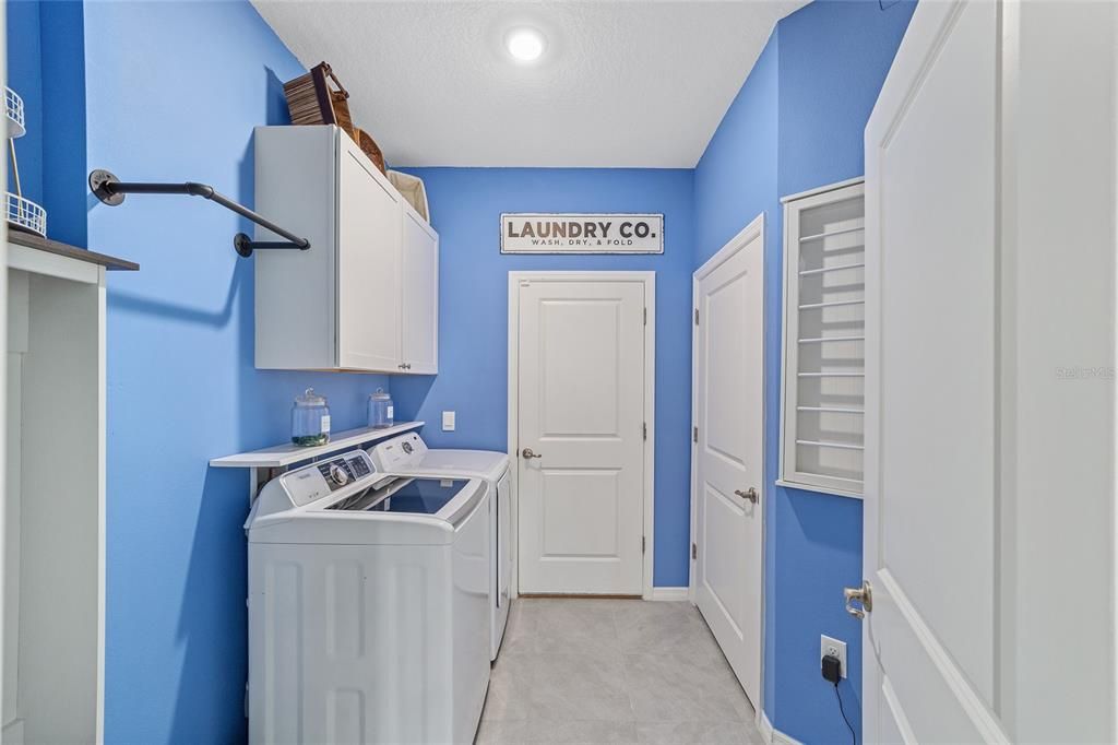 Laundry Room with Cabinets and Storage Closet