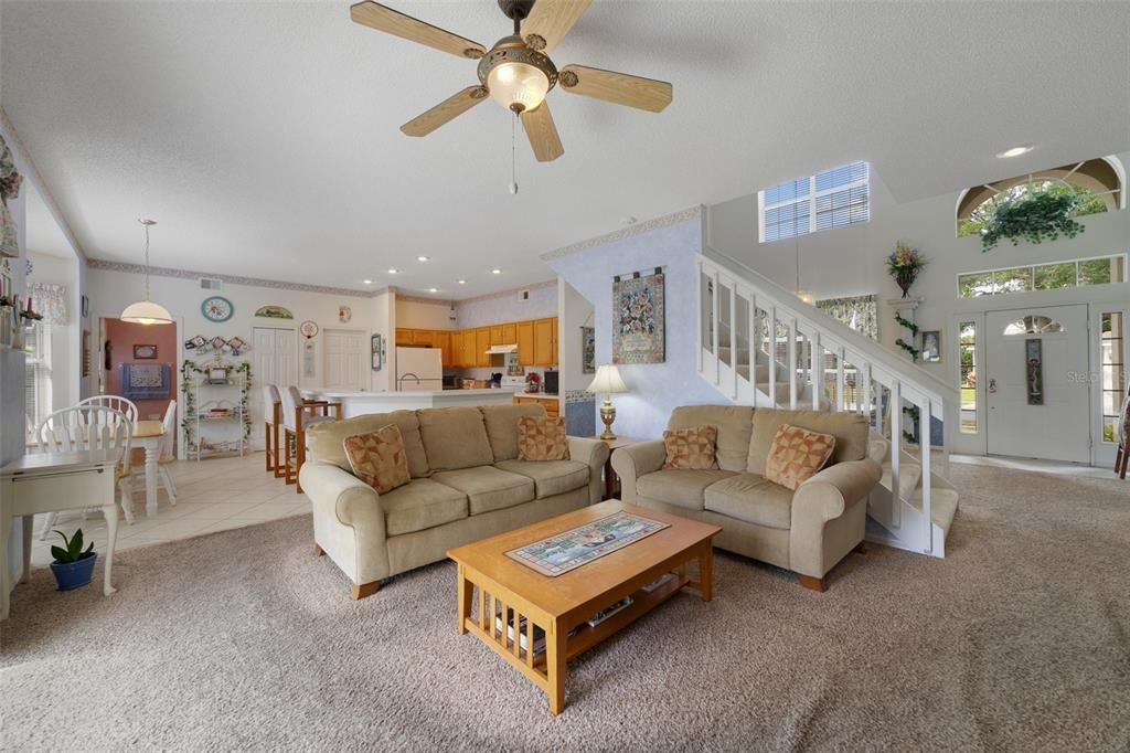 Follow the natural flow into the spacious kitchen complete with a casual dining area, open to a generous family room with sliding glass door access to the COVERED LANAI.