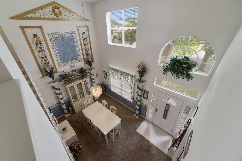 The two story portico entrance welcomes you home and invites you to step inside where you will find a formal dining room with a soaring ceiling open to the loft above and a bright flowing floor plan!