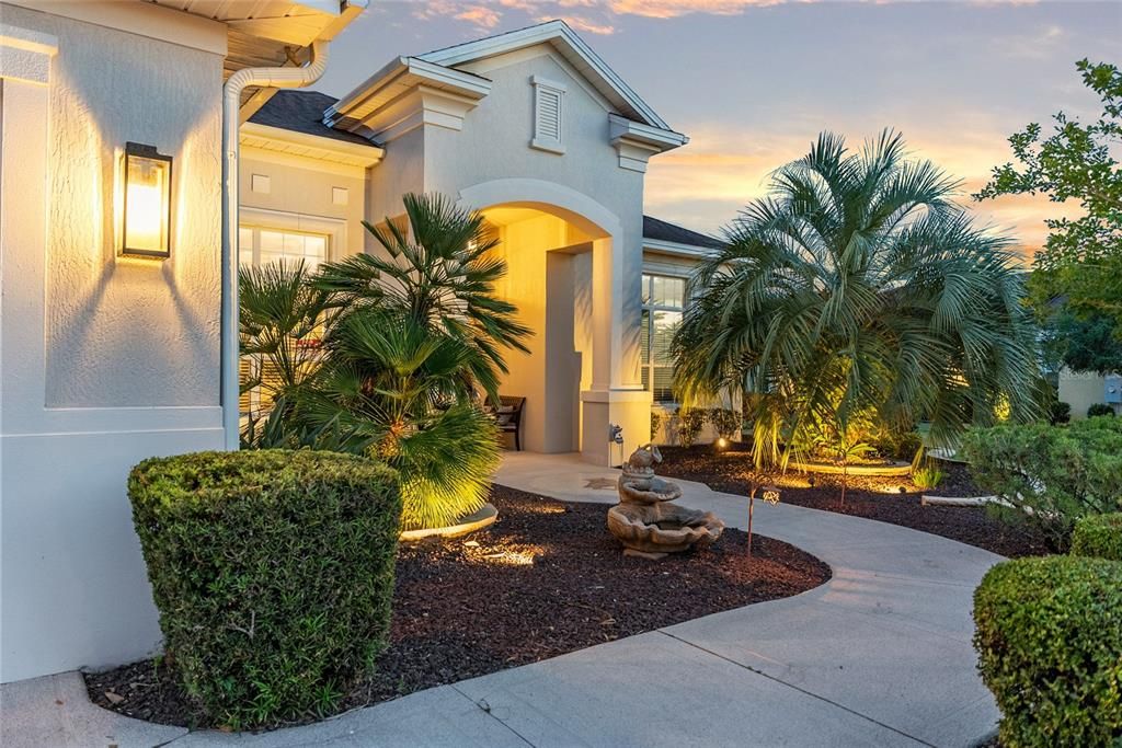 Walkway to COVERED FRONT PORCH @ Dusk - showcasing the professionally designed outdoor lighting.