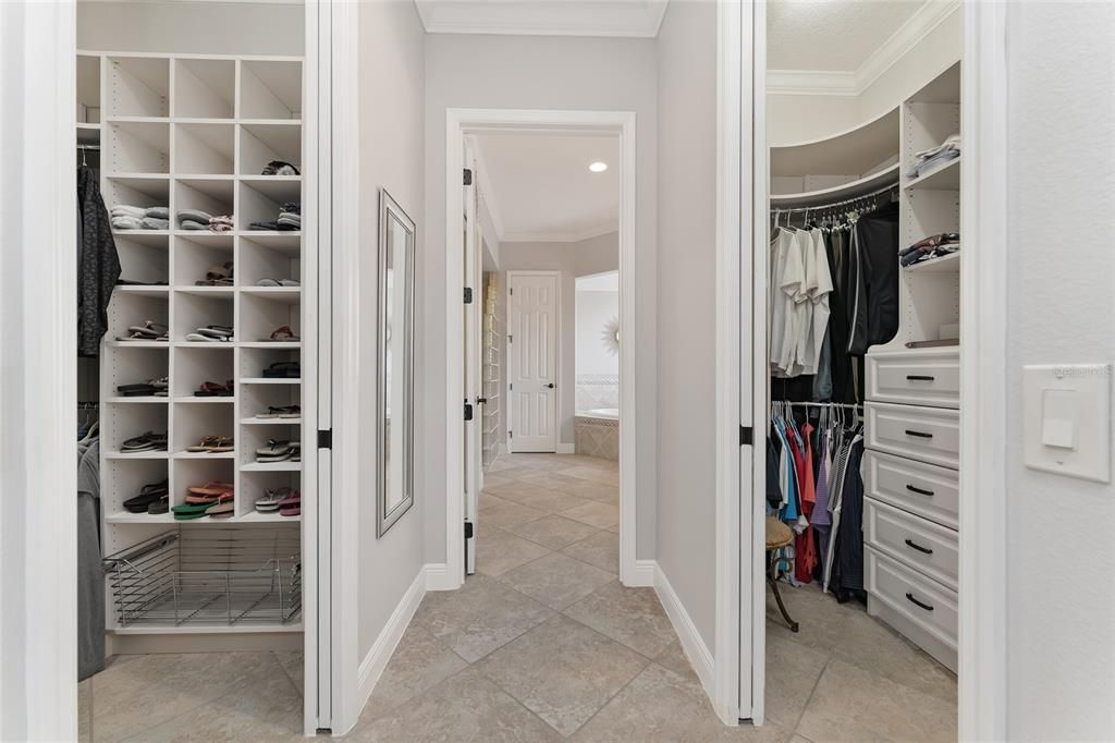 View of HALLWAY to ENSUITE BATHROOM shows flanking double CLOSETS w/ POCKET DOORS & CUSTOM CLOSET ORGANIZATION SYSTEMS.