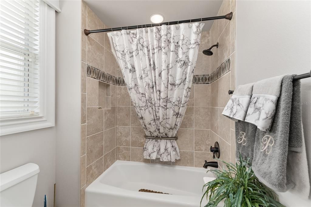 BATHROOM 2 has a window to provide NATURAL LIGHT. Note TUB/SHOWER COMBO w/ TILE SURROUND & COMFORT HEIGHT TOILET.