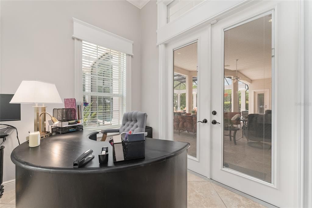 Close-up view of FRENCH DOORS w/ BUILT IN BLINDS leading to the OPEN LANAI & OUTDOOR OASIS. Note extensive woodworking features around TRANSOM WINDOW overhead & FRENCH DOORS.