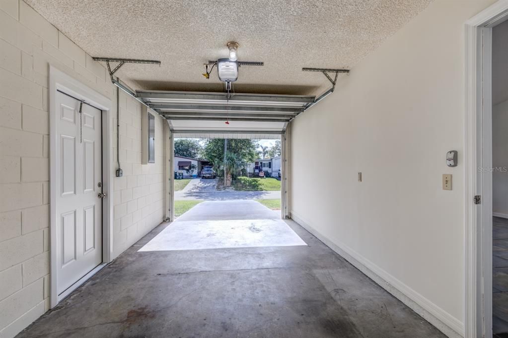 Single car garage with access door to side yard