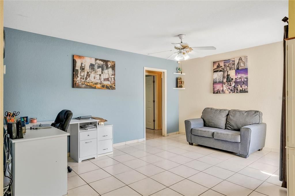 The family room off the kitchen with sliding glass doors out to the patio provides a more relaxed environment.