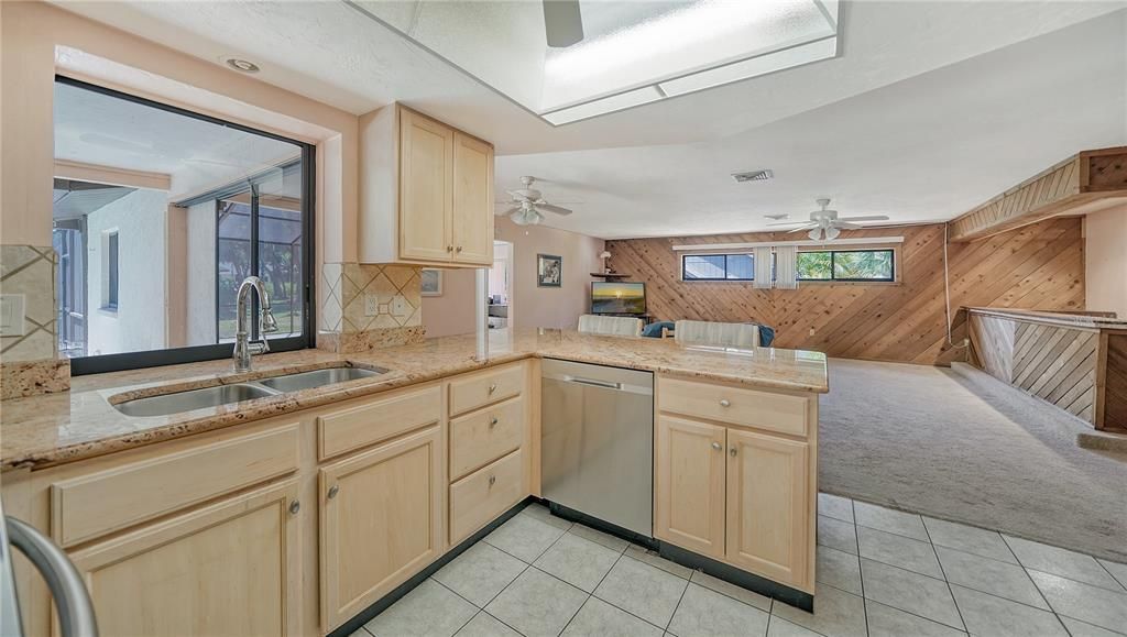 Kitchen is open to family room and features a pass-through window and counter on the lanai side.
