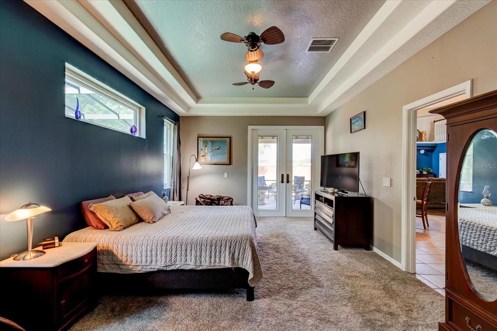 Primary Bedroom has Double Tray Ceilings and French Doors to the Lanai.