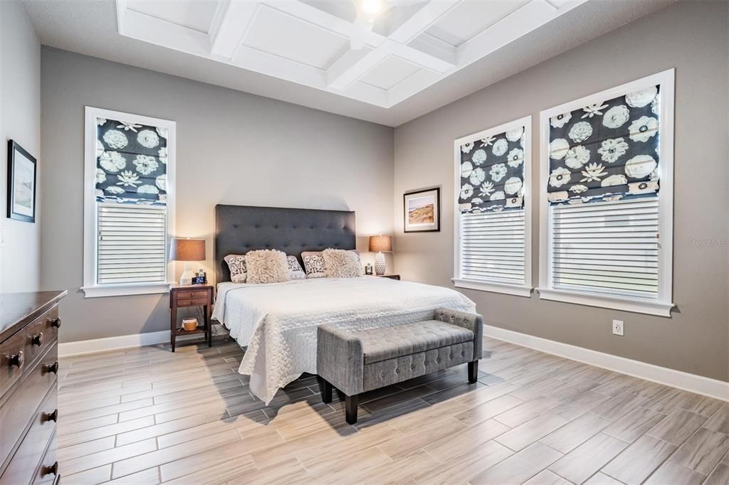 Primary bedroom with detailed coffered ceiling