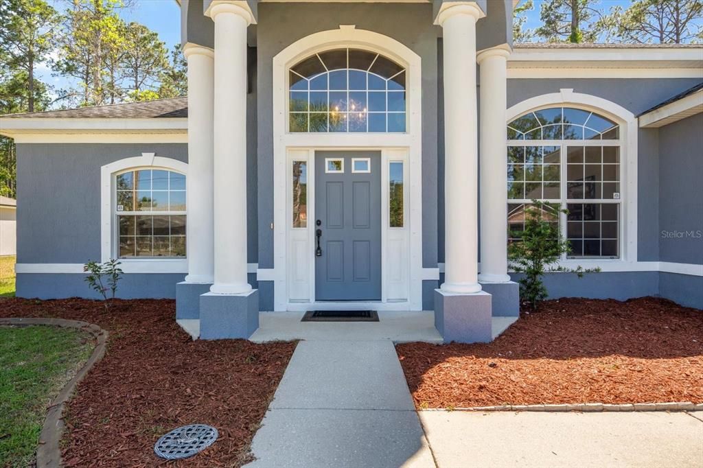 Walkway to front door-PORTICO-Covered area with double columns.