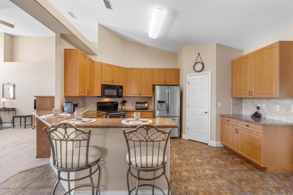 Kitchen: granite counters and breakfast bar that seats 4-tile flooring, large walk in pantry.
