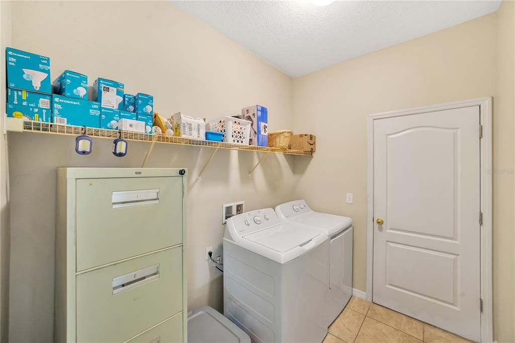 GOOD SIZED INTERIOR LAUNDRY ROOM WITH WASHER AND DRYER.  OPENS OUT INTO THE GARAGE.