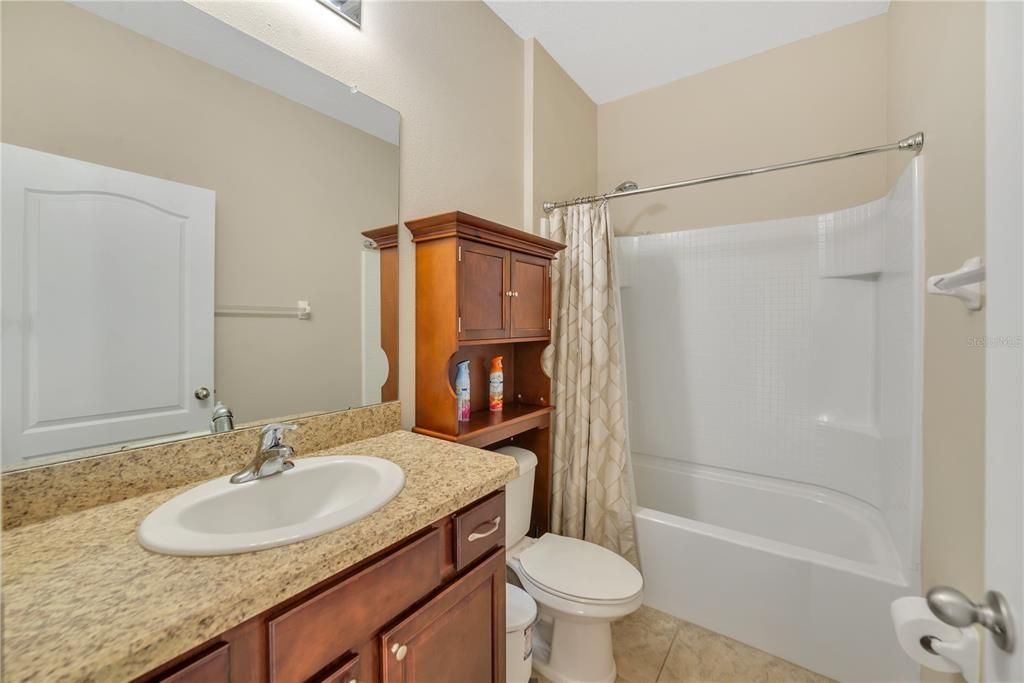 GUEST BATH WITH ADDITIONAL STORAGE OVER COMMODE.