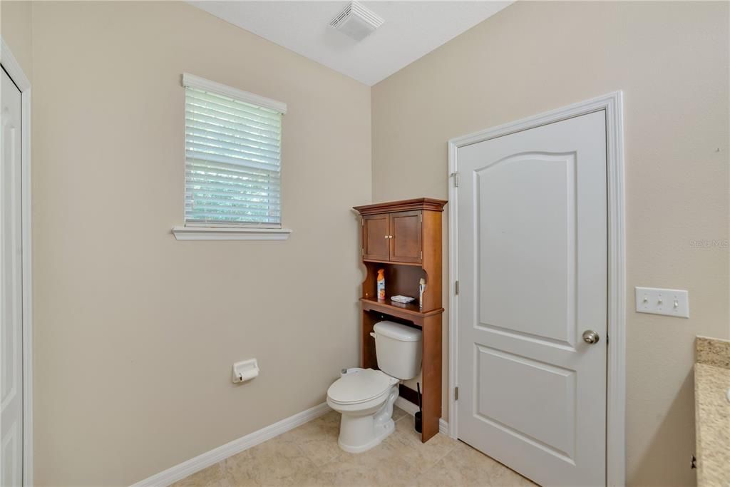 STORAGE OVER COMMODE AND PRIVATE WINDOW.