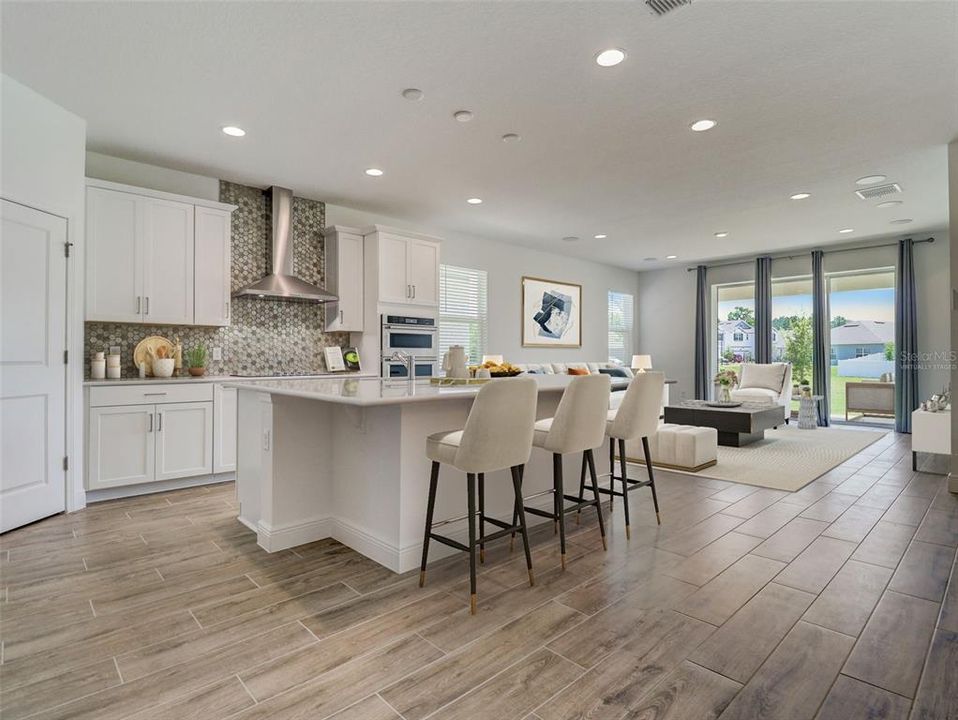 The home chef will revel in the details of the kitchen; from the 42” CABINETRY, UPGRADED STAINLESS STEEL APPLIANCES, QUARTZ COUNTERTOPS, large ISLAND, chic modern backsplash and the pantry adds even more storage space. Virtually Staged.