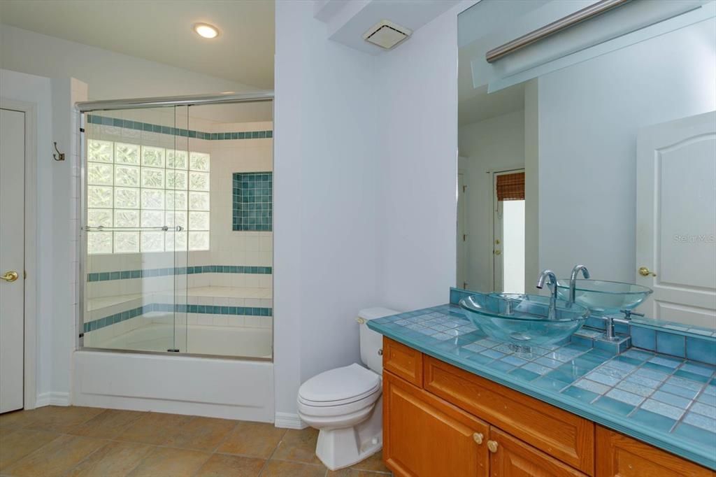 Hall Bath with built in tub/shower, new toilet, new glass sink. Also, opens to the covered patio and could be your future pool bath!  (Pool not included:)