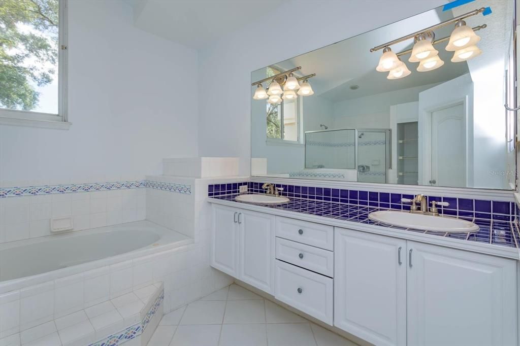 Master bathroom with double vanity, soaking tub and a shower.