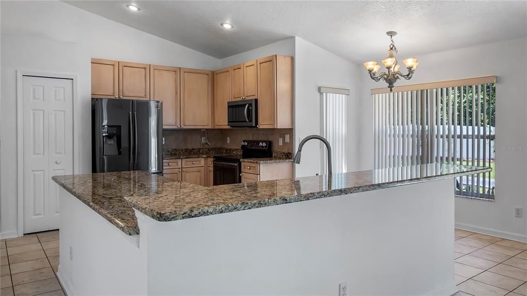 Breakfast Bar and Kitchen with Granite Counter tops