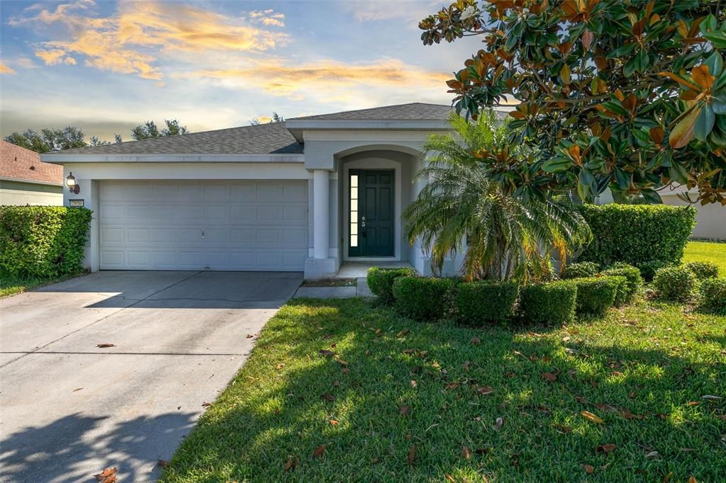 Welcome to your new home in Clermont, where a majestic magnolia tree and lush landscaping greet you at the door.