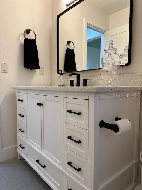 GUEST BATHROOM WITH SOLID WOOD VANITY AND QUARTZ COUNTERTOP