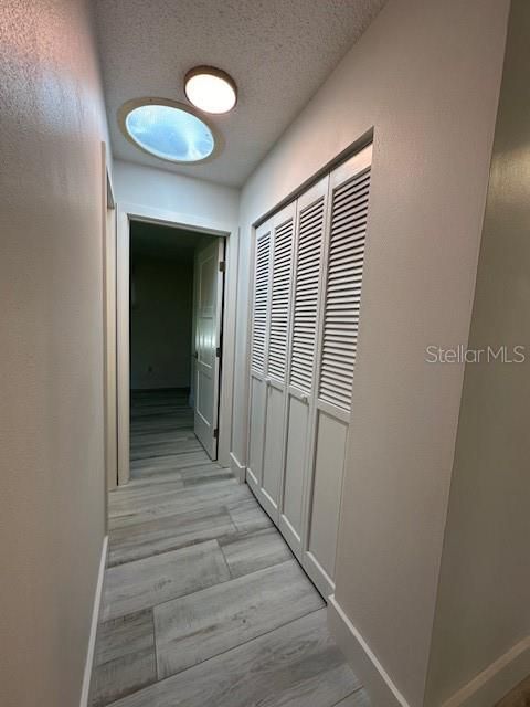 HALLWAY WITH SUN TUNNEL AND LARGE STORAGE CLOSET