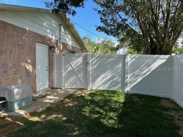 NEW VINYL FENCE WITH GATE ON WEST SIDE OF HOUSE