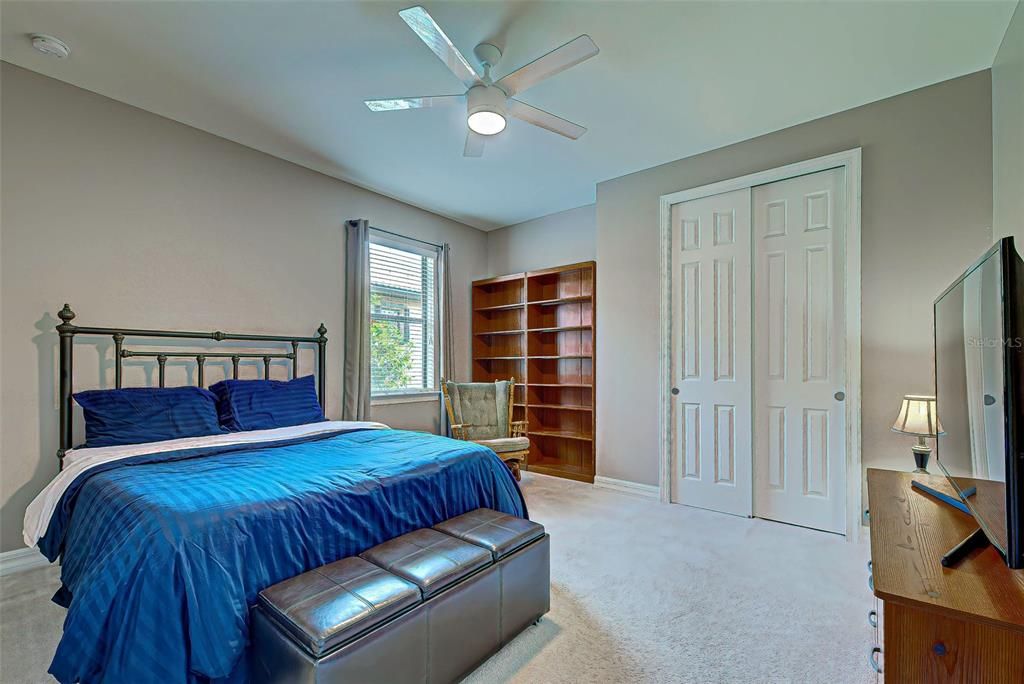 Second guest room has bookcase storage