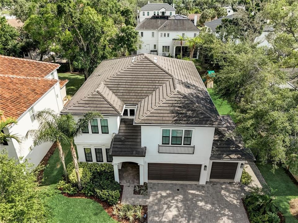 Huge pavered driveway to 3 car garage, irrigation and mature landscaping with up lighting.