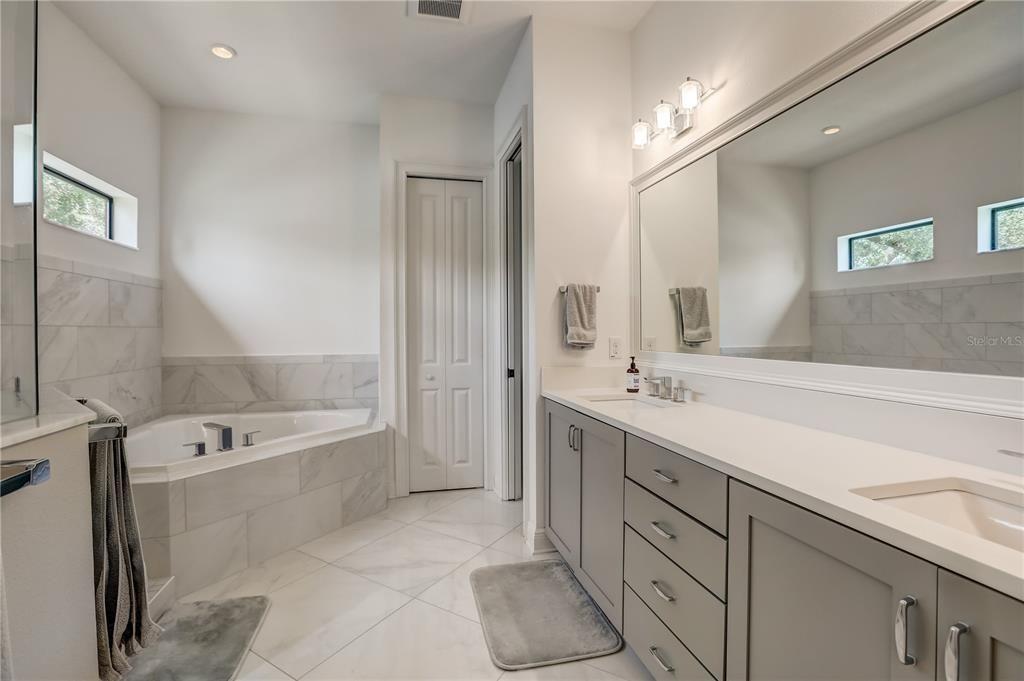 Owners suite bathroom with dual vanities, 2 person soaking tub and walk-in shower