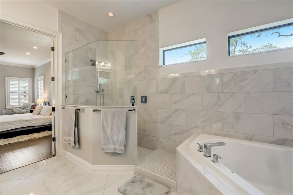 Owners suite bathroom with dual vanities, 2 person soaking tub and walk-in shower