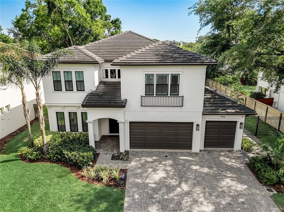 Huge pavered driveway to 3 car garage, irrigation and mature landscaping with up lighting.