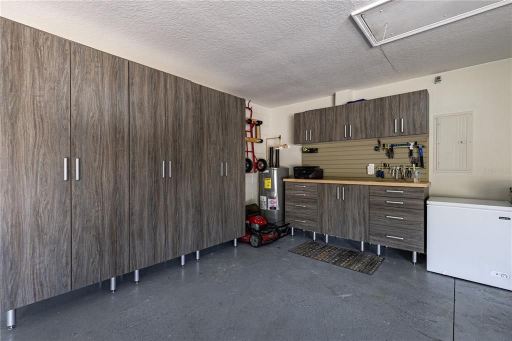 Generous Garage with Closet and Work Bench