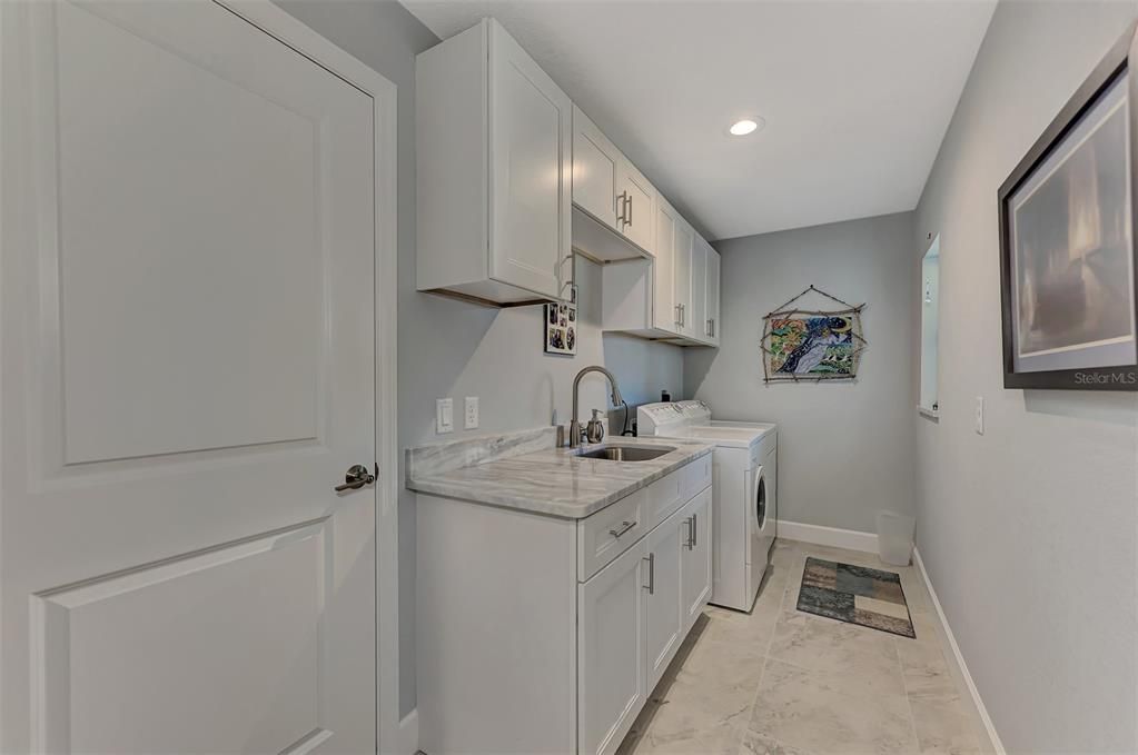 Indoor laundry room with sink