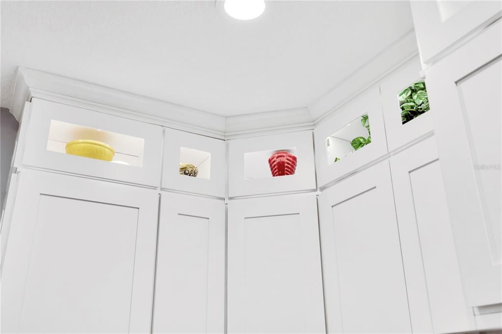 lovely top of the kitchen cabinets with back lighting and exquisite crown molding!