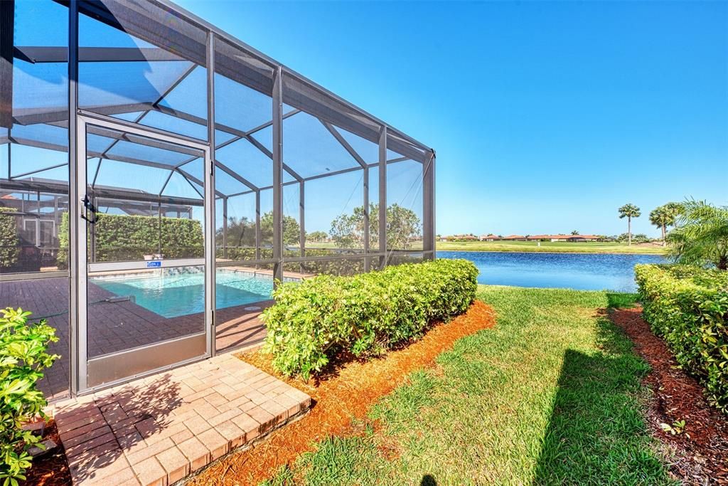 The yard beyond the pool and cage is maintained by the HOA - the view is spectacular.