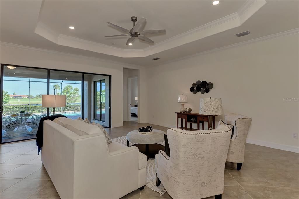 The great room and lanai with pool/spa on water.