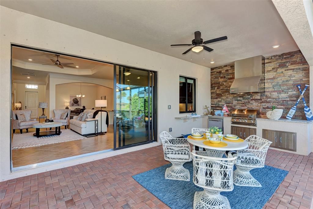 The lanai has a beautiful outside kitchen, with plenty of recreation space.  The sides of the lanai have privacy screens as does the primary bedroom.