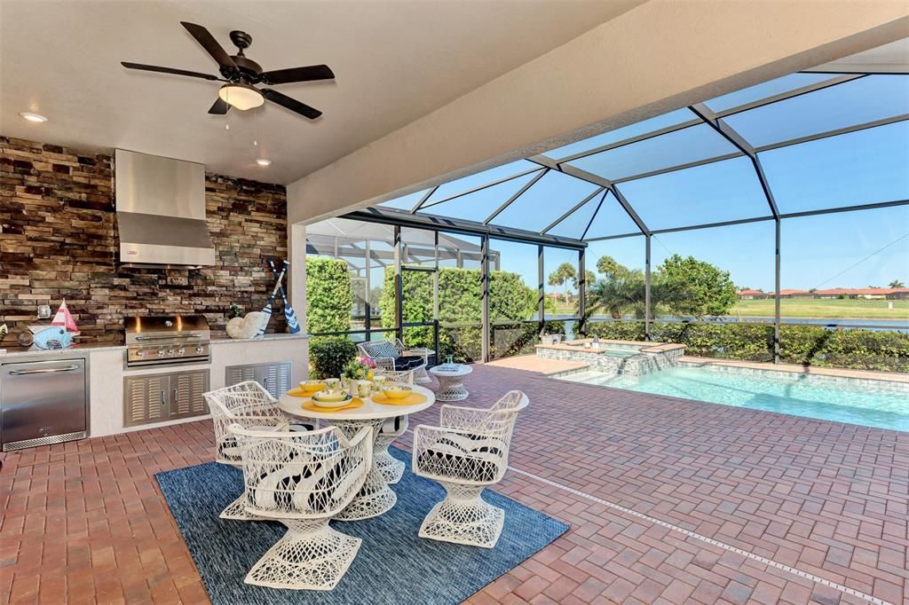 The lanai has a beautiful outside kitchen, with plenty of recreation space.  The sides of the lanai have privacy screens as does the primary bedroom.