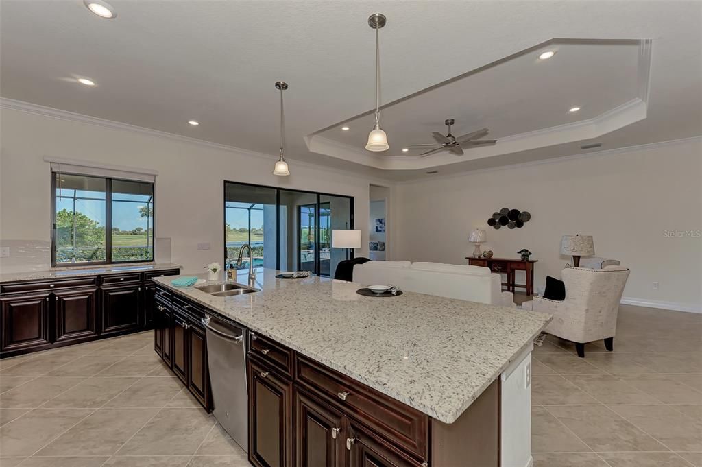 The kitchen in the Angelina has a large counter area for dining and entertaining!  /There is a window as well for a pass through from the outside kitchen