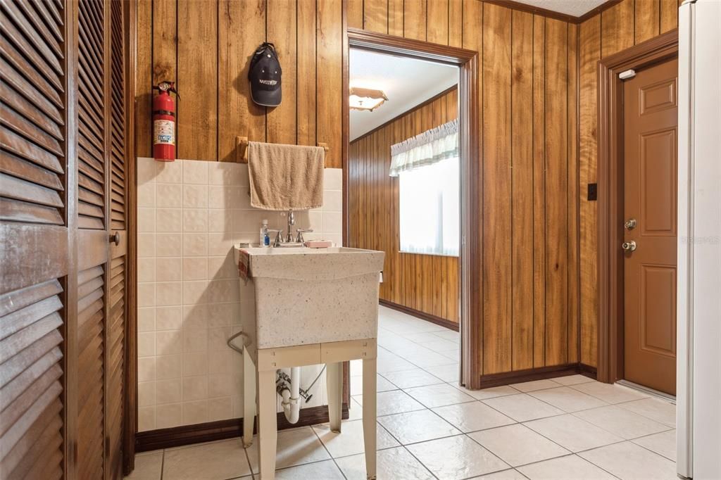 Utility sink and Laundry closet in mudroom.