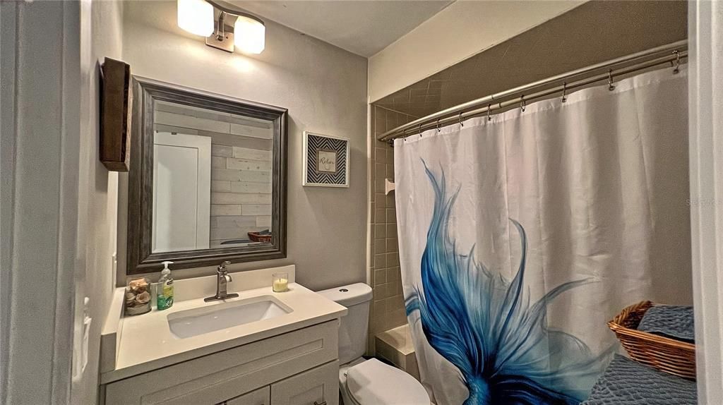 Hall bath serves two smaller bedrooms